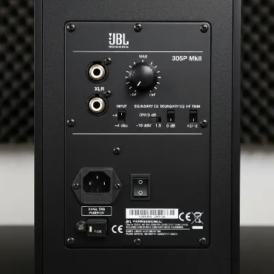 Close-up of the JBL 305P MkII rear panel showing input connections and EQ controls.
